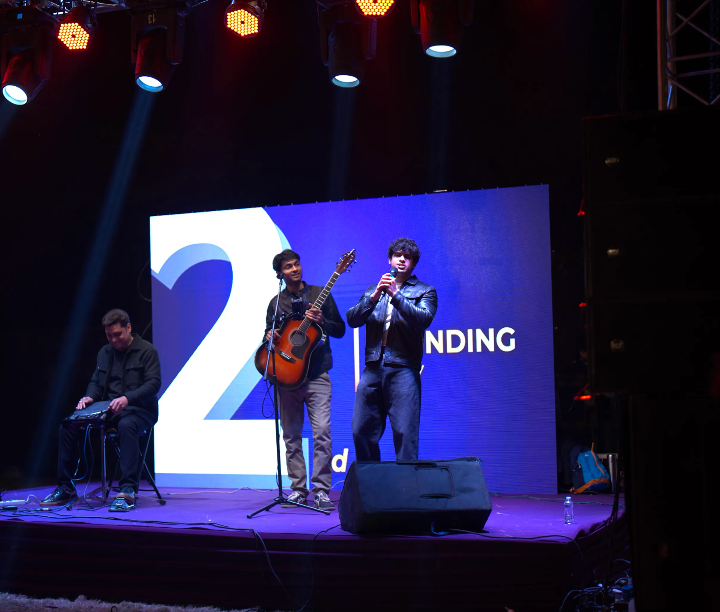 Arnab singing on stage with the band at the Hexalog anniversary night