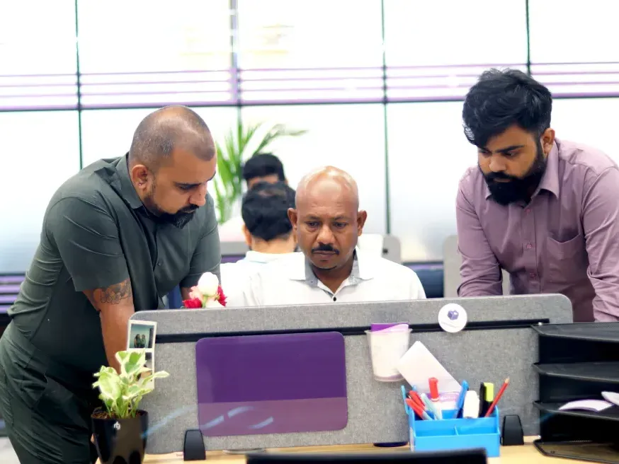 Hexalog colleagues reviewing work together at a desk