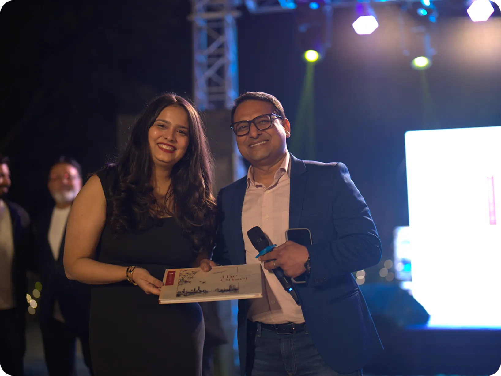 Rythm and Saurabh on stage with an award at a Hexalog event